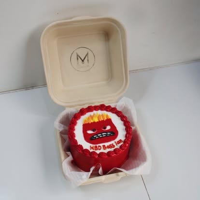 A red character bento cake in its snack box