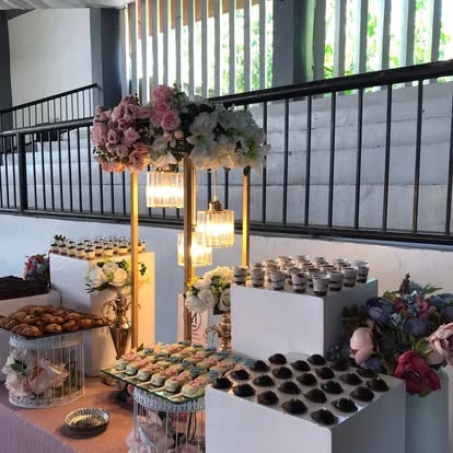 A styled dessert table with crystal stands, florals and shooters